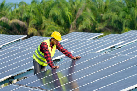Engineer working on checking equipment in solar power plant,Climate change and renewable energy concept.の写真素材