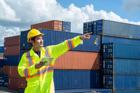 Foreman worker with digital Tablet at container terminal port,Business Logistics import export...