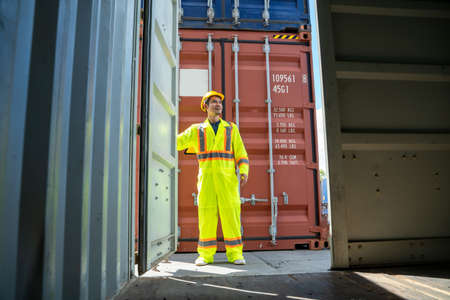 Container worker checking container box for logistic export and import in dock.の写真素材