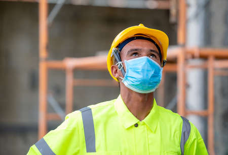 Construction worker wear protective face masks for safety in construction site,Concept of prevention...