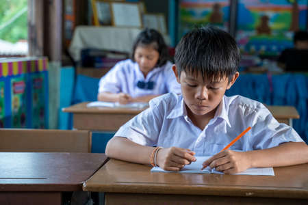 Asian elementary students in uniform studying together at classroom,Education,Student,People concept.の写真素材