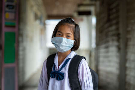 Asian students wearing protective mask to Protect Against Covid-19,Back to school reopen their school,Education,Elementary school.の写真素材