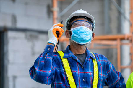 Construction worker wear protective face masks for safety in construction site,Concept of prevention...