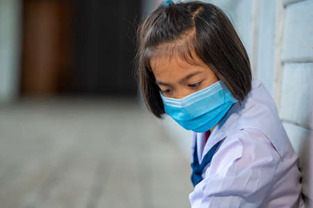 Elementary school students wearing disease prevention masks,Child with face mask going back to school after covid-19 quarantine and lockdown.の写真素材