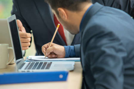 Business people signing a contract a document.