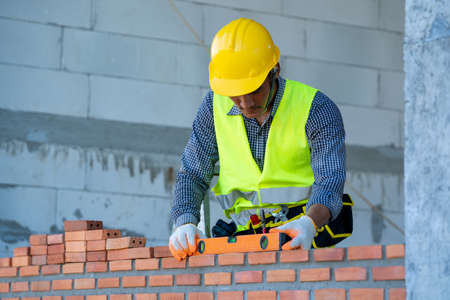 Professional worker building brick walls with cement.の写真素材