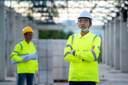 Engineers discussion with architect about detail of building at construction site.の写真素材