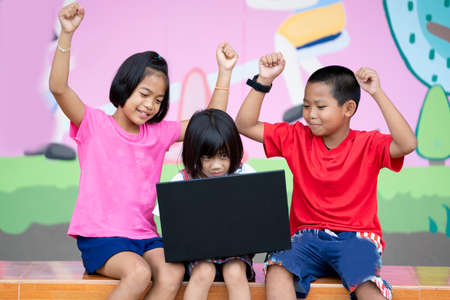 Children at laptop computer in elementary school,Back to school education concept.の写真素材