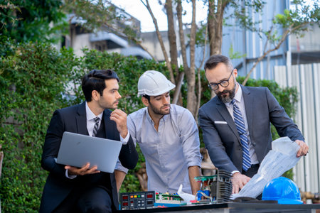 Businessmen and engineers discuss of renewable energy working on an innovative more efficient solar panel battery concept.の写真素材