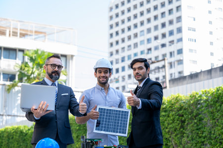 Businessmen and engineers discuss of renewable energy working on an innovative more efficient solar panel battery concept.の写真素材