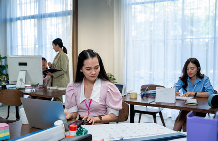 Asian business women work wear protective face mask due covid working in modern office.の写真素材