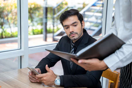 Waitress taking an order from customer in cafe,Service mind concept.の写真素材