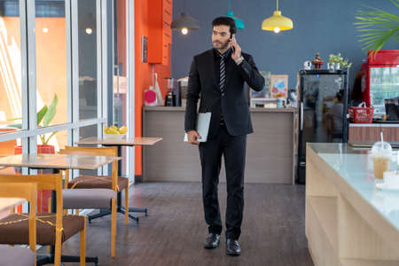 Portrait of handsome businessman are talking on the phone  at cafe.の写真素材