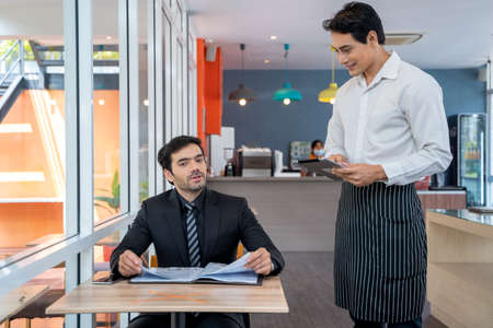 Staff taking orders from customer in coffee shop,Food and drink business concept.の写真素材