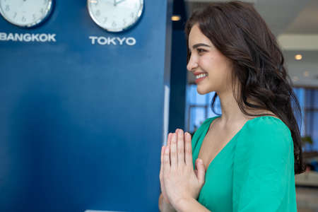 Guest checking in at counter with reception at hotel.の写真素材