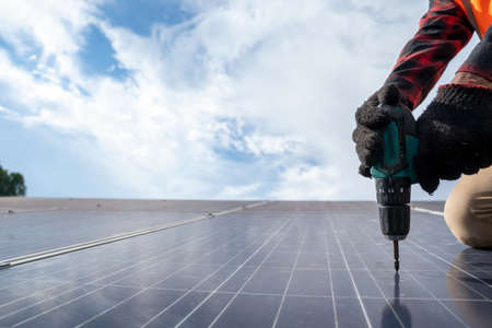 Electrical engineer or technician maintenance electrical system working on checking and maintenance equipment at solar power plant,Clean and green alternative energy concept.の写真素材
