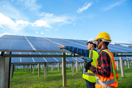 Engineer working on checking equipment in solar power plant,solar power plant to innovation of green...