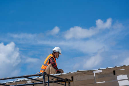 Roofing,Construction workers wearing safety harness checking and installation assembly of new...