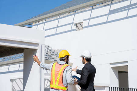 Architect and foreman meeting at construction site,Architect inspects the construction site,Construction project concept.の写真素材