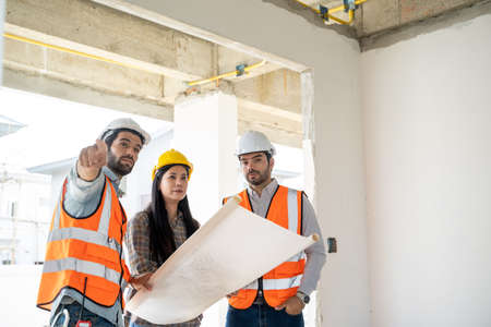 Architect discussing with foreman about project in building construction site,Construction project...