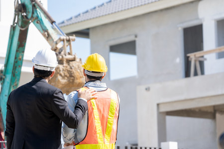 Engineers are discussing data working and tablet or laptop with architectural project at new construction site,Engineering tools and construction concept.の写真素材