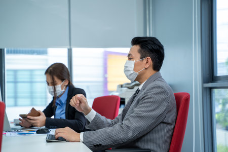 Businessman working and wear mask for protect Covid-19 or corona virus disease at modern office,Healthcare concept.の写真素材