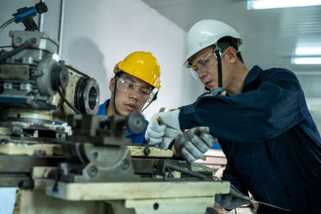 Engineer and factory worker are working on projects at machine for steel structure industry.