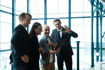 Team business people using tablet discussing online project or making conference video call together...