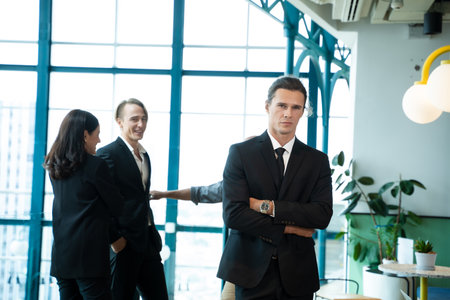 Portrait businessman with teammates discussing in the background.の写真素材