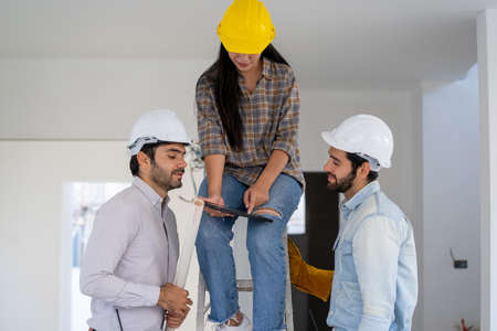 Architect and engineer discussing planning for a building a new home at construction site,Architect...