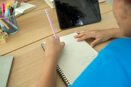 Student children doing test in primary school,Children writing notes in classroom,African school child writing during the lessonの写真素材