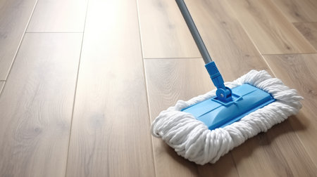 Cleaning white parquet floor with mop.の素材