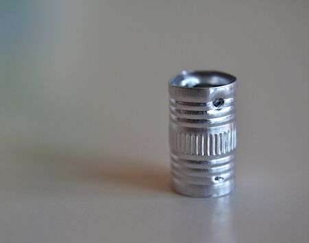 Small metal tube, glossy cylindrical and vertically positionedの写真素材