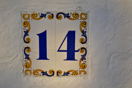 Tile painted with the number fourteen