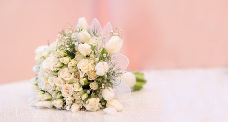 The bride's bouquet, white roses, tulips, delicate flowers, use as background or texture, soft pastel colors.の写真素材