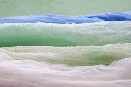 White, green, emerald, blue shades gauze dyed fabric beautiful backgroundの写真素材