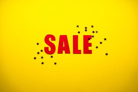 Black friday concept.
Sale in red letters on a yellow background with confetti.の写真素材