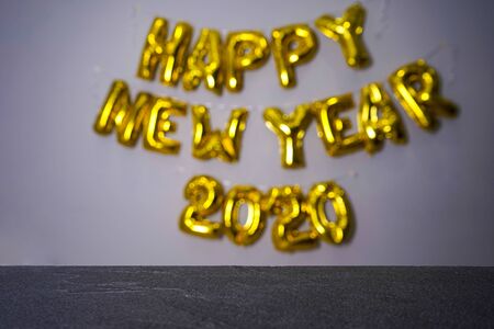 Celebrating New Year 2020, golden foil balloons 2020 on gray backgroundの写真素材