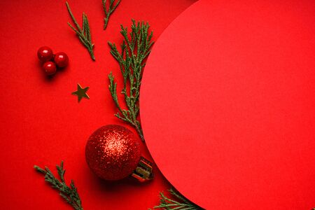 Christmas composition. Christmas red decorations on a red background, place for text. Flat lay.の写真素材