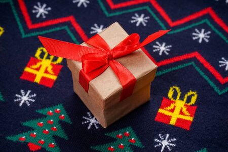 Christmas sweater with a pattern with a gift, top view.