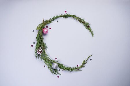 Christmas decorations, fir branches with colorful balls on a gray background. Flat lay, flat lay.の写真素材