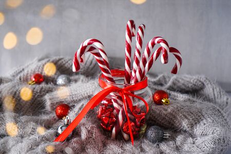 Christmas concept. Christmas composition with sweets and Christmas decorations on a gray plaid. Gray background.の写真素材