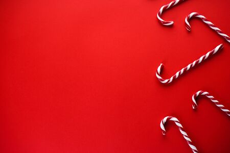 Christmas concept. Christmas candy on a red background. Traditional christmas sweets. Flat lay, place for text.の写真素材
