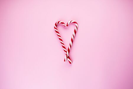 Christmas heart made of sweets on a pink background. Flat lay.の写真素材