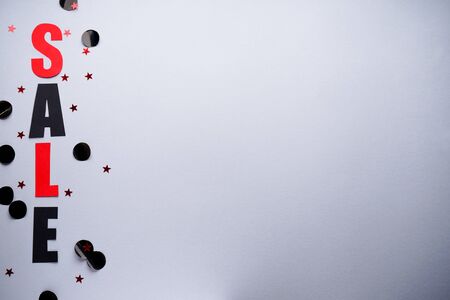 Black friday concept. Sale on a gray background with confetti, place for text top view.の写真素材
