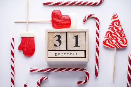 Christmas flat lay composition. Christmas vintage style wooden calendar with Christmas candies on a gray background.の写真素材