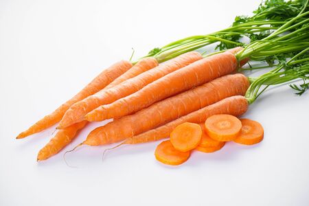 Fresh carrots with sliced and leaves on white background.の写真素材