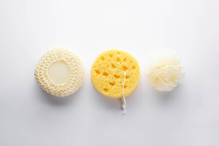 Three different bath sponges on a gray background, flat lay. Bath accessories. Hygiene products.の写真素材
