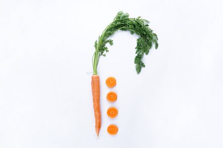 Flat lay composition with ripe fresh carrots on white background.