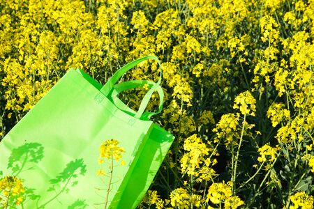 Eco-bag on background of rapeseed. Mockup for design.の写真素材